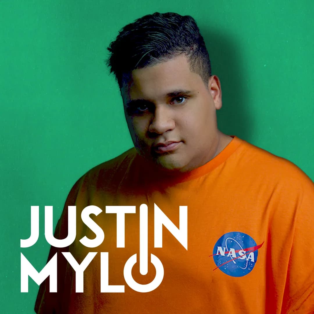 Justin Mylo wearing an orange NASA t-shirt stands against a green background, with the text "JUSTIN MYLO" in the foreground.