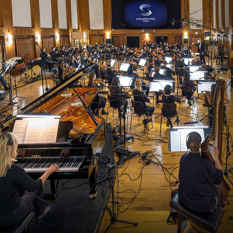 image of the Synchron Stage Orchestra performing in a wooden panelled room