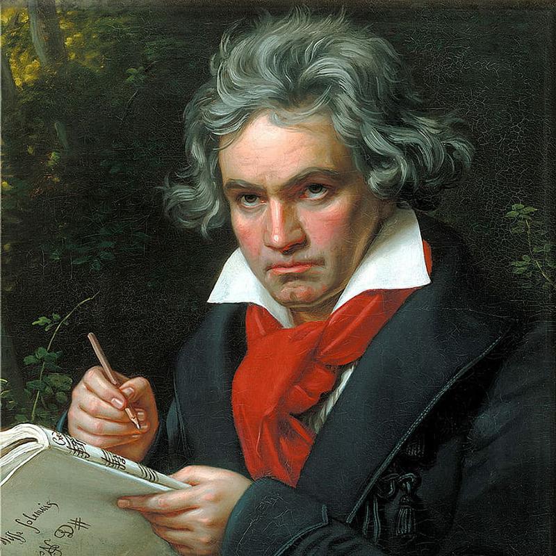 A drawn image of Ludgwig Van Beethoven holding a pen and sheet music