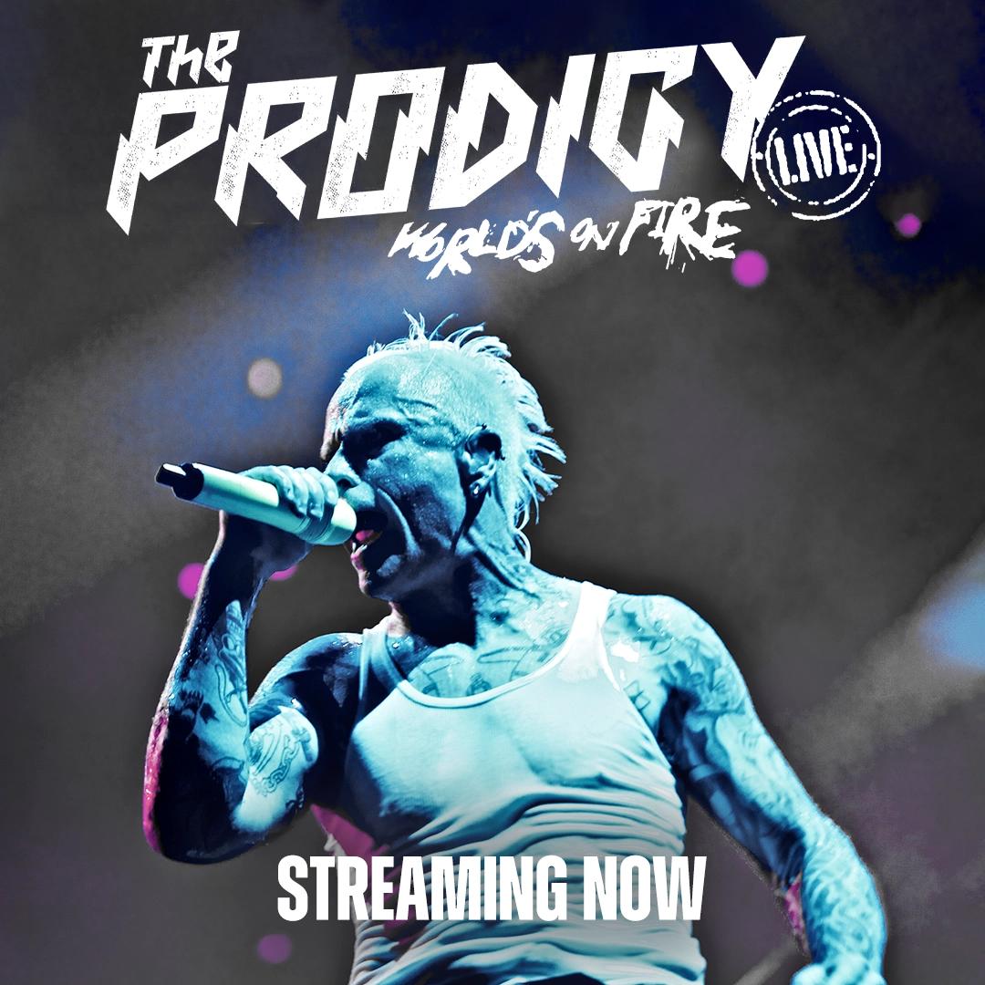 The Prodigy frontman with tattoos and a mohawk sings into a microphone. Text: "The Prodigy (Live) World's on Fire - Streaming Now.