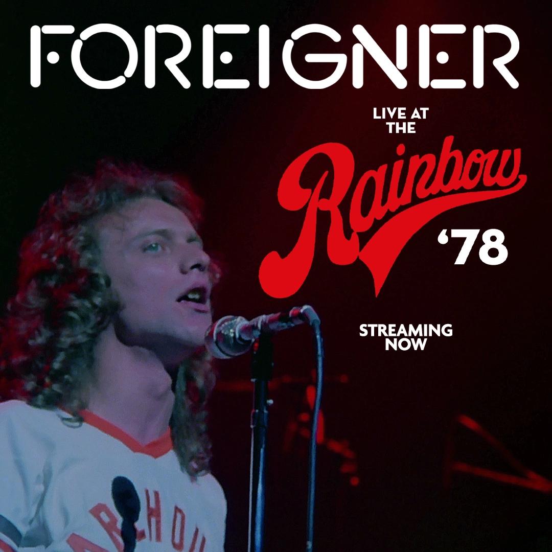 Foreigner performing on stage with text "Foreigner Live at the Rainbow '78 Streaming Now" in the background.