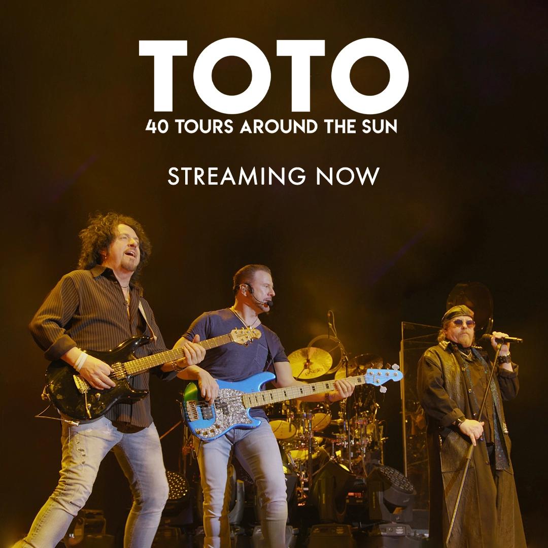 Band Toto performing live on stage with text, "TOTO - 40 Tours Around The Sun - Streaming Now," shown above.