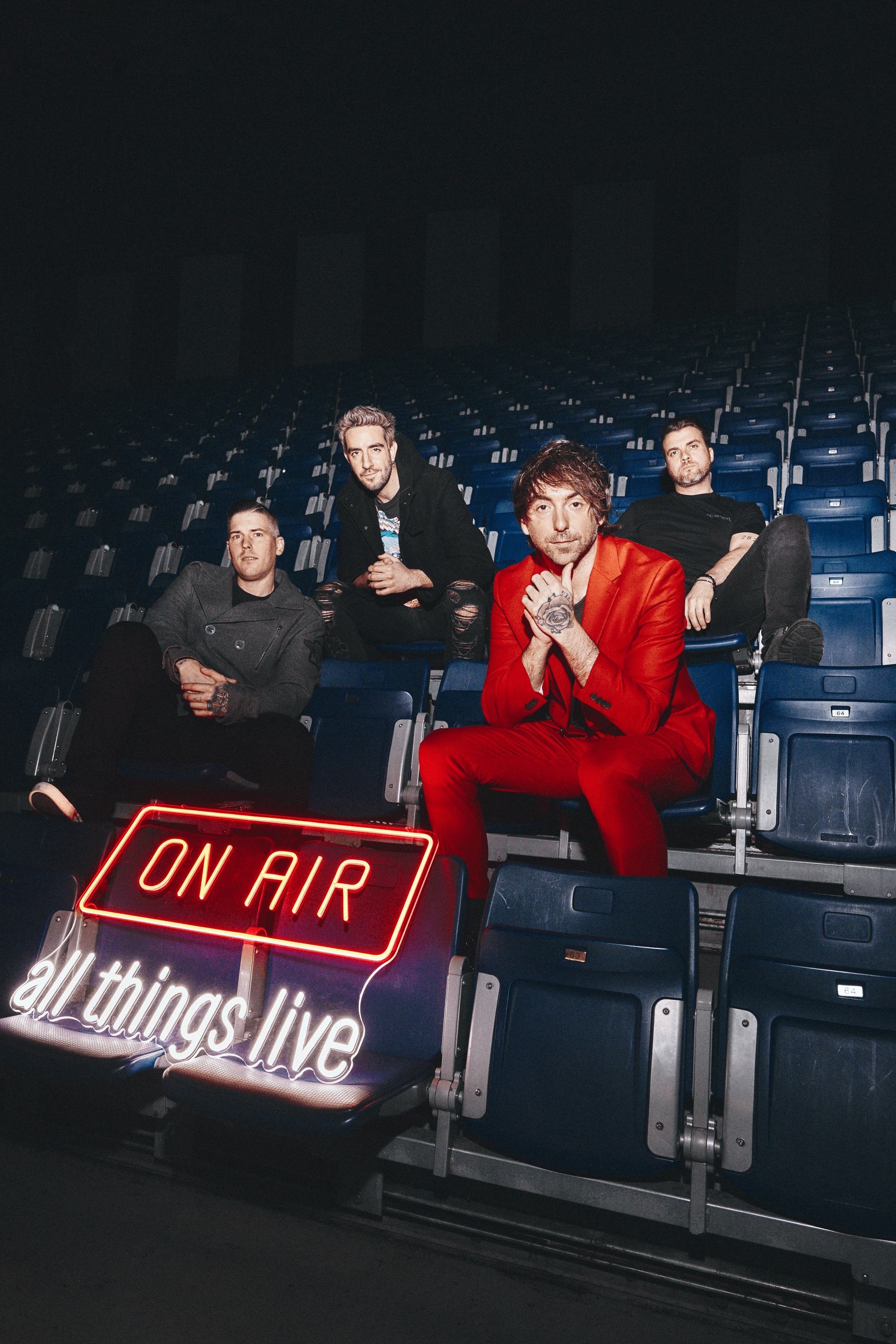 All Time Low sat in front of the On Air neon sign at OVO Arena Wembley in March 2023