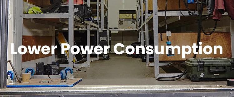 Interior of a workshop with shelves and electrical equipment, featuring text "lower power consumption".