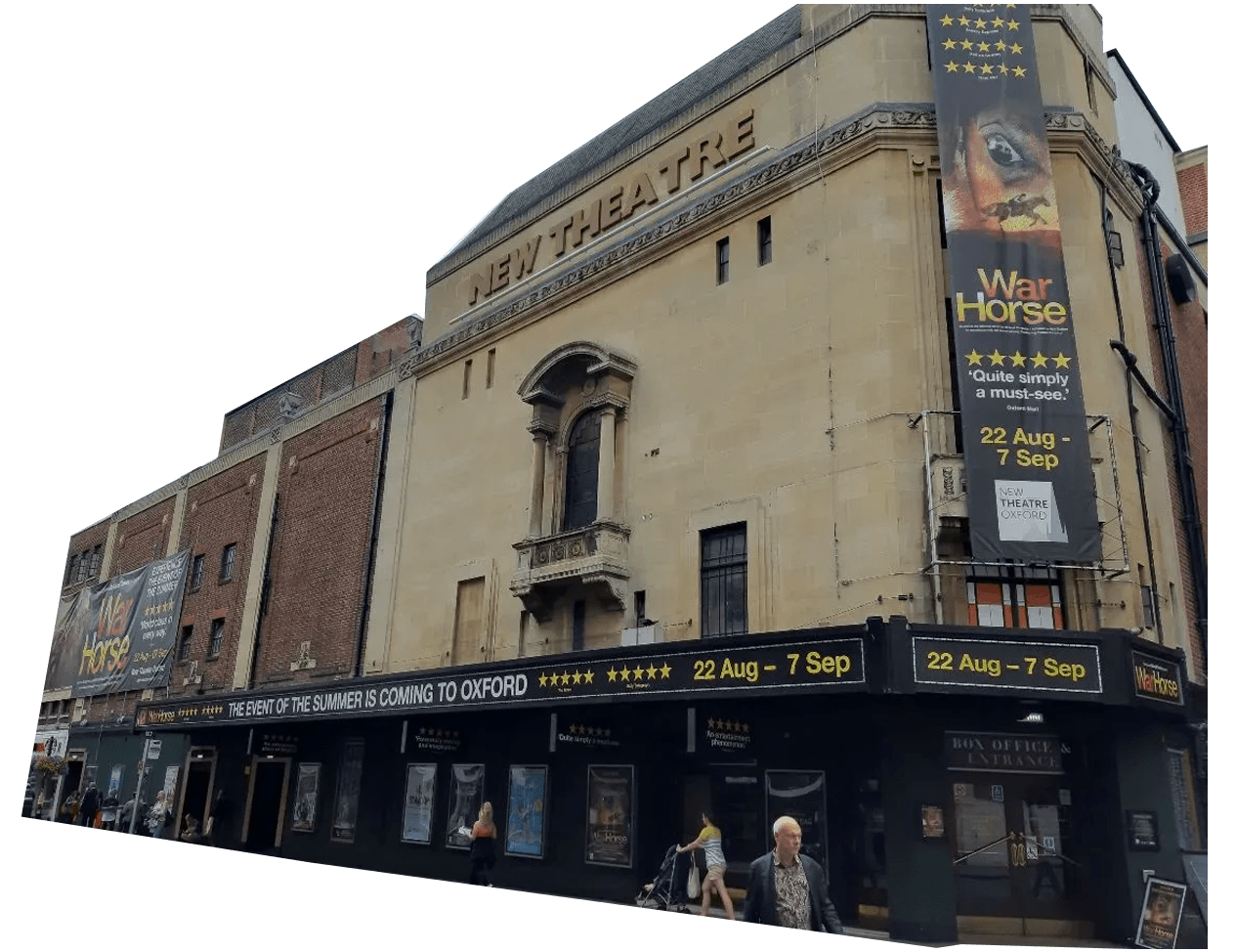 A street view of New Theatre Oxford with large banners advertising the play "War Horse," and several people walking past the entrance.