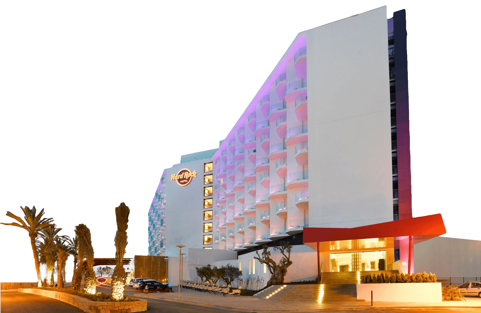 A modern hotel building with purple and pink exterior lighting, palm trees, and the Hard Rock Hotel logo at sunset.