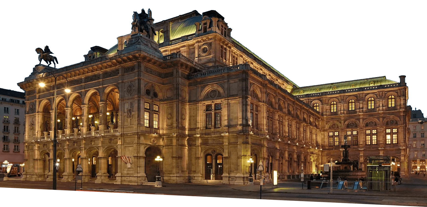 The Vienna State Opera building is illuminated at dusk, showcasing its ornate façade, arched windows, statues, and architectural details.