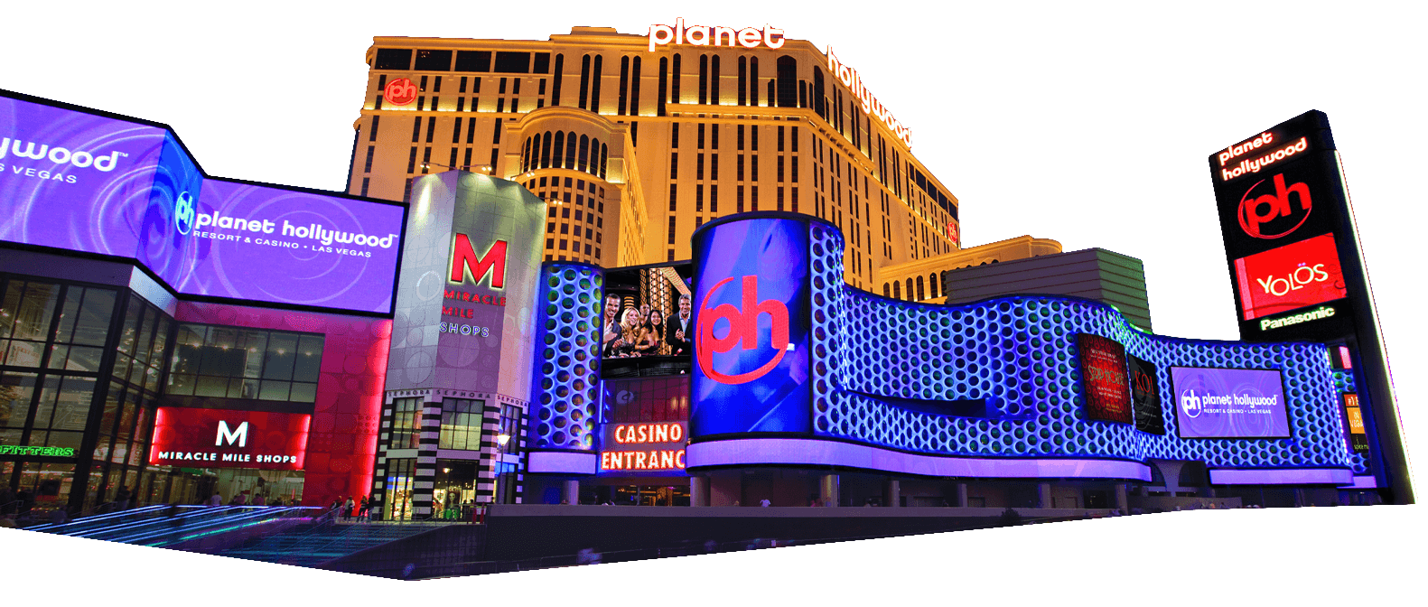 Night view of the illuminated exterior of Planet Hollywood Resort & Casino in Las Vegas, with bright signs and digital billboards.