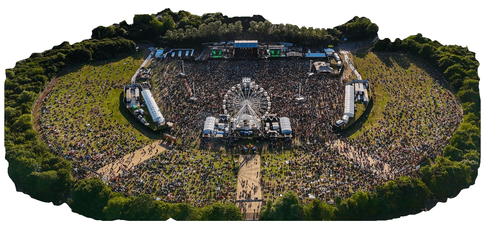 Aerial view of a milton keynes bowl with a Ferris wheel at the center, surrounded by stages, tents, and crowds, all set within a grassy, tree-lined area.