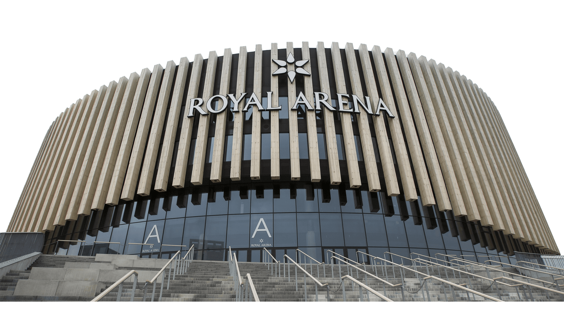 Front view of Royal Arena, a modern circular building with vertical slats, large glass windows, and exterior staircases leading to multiple entrances.