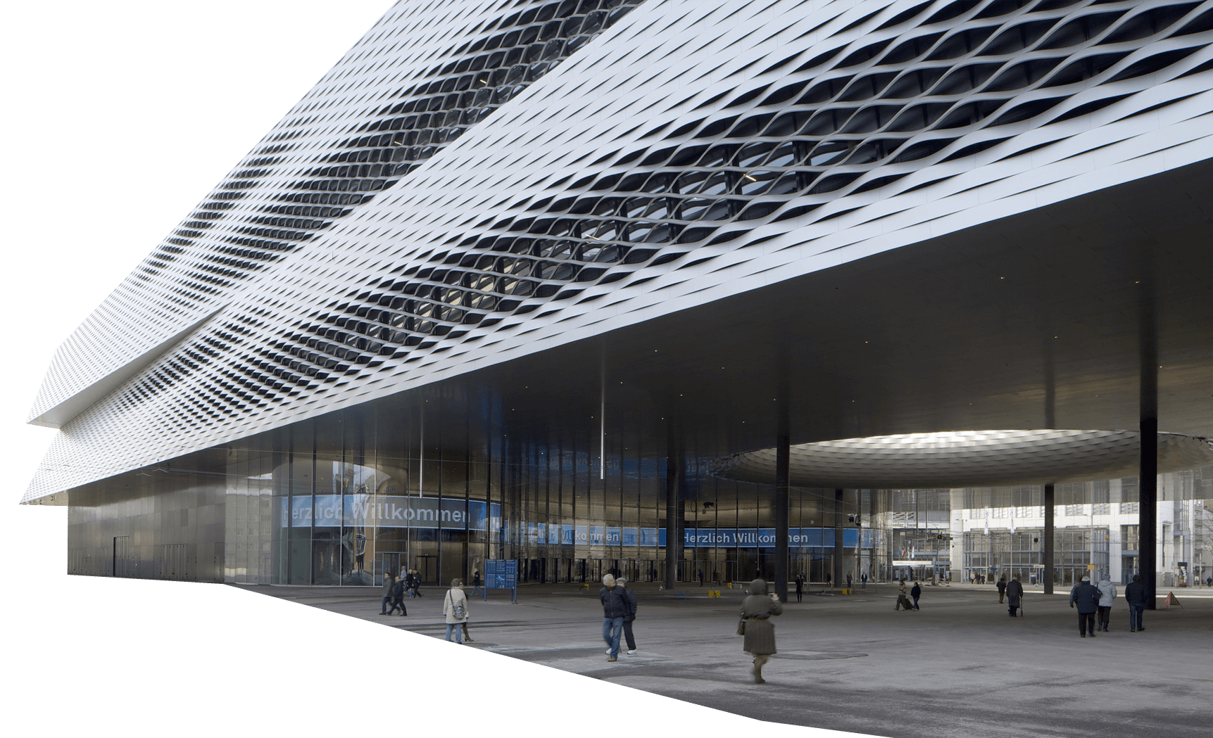 Messe Basel building with a metallic, patterned facade and a large covered entrance; several people walk near the entrance on a paved open area.