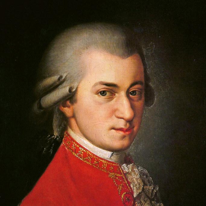 Wolfgang Amadeus Mozart wearing a red jacket with curls in in hair