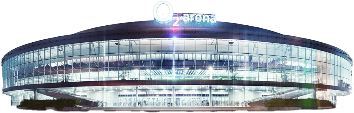 Exterior view of the 02 arena prague with signage reading "O2 arena" on top, featuring multiple entryways and illuminated by spotlights.