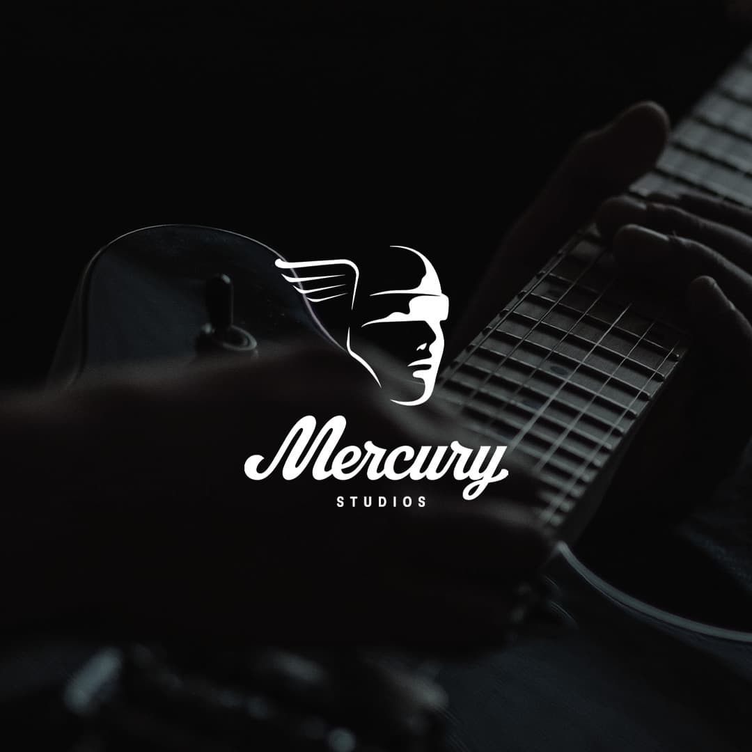 A close-up of a person playing a guitar in low light with the Mercury Studios logo, featuring a winged head, overlaid in white.