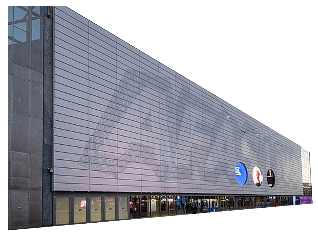 AFAS Live building with a gray facade featuring various inscriptions. Two circular signs are visible, and a few people walk past the entrance.