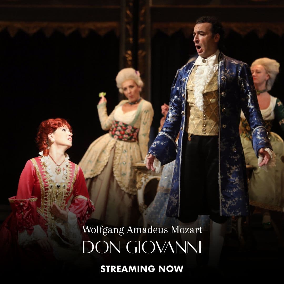 Opera performers in period costumes are on stage; a man in a blue coat sings while a woman in red sits nearby. Text below reads “Wolfgang Amadeus Mozart Don Giovanni Streaming Now.”.