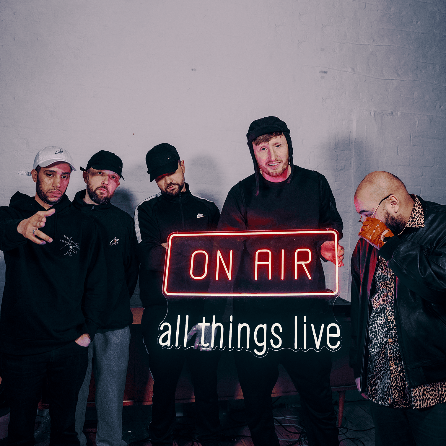 Kurupt FM stand in front of an On Air neon sign ahead of the live concert stream from Printworks London
