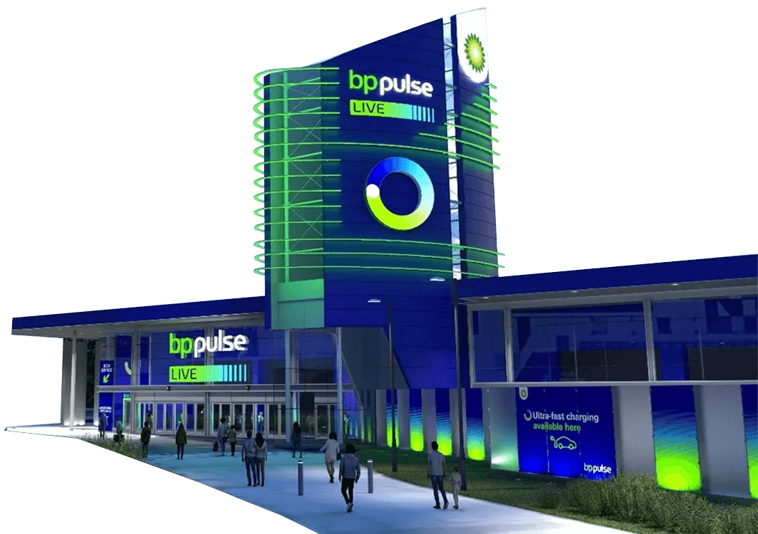 A modern building with "bp pulse LIVE" signage, green lighting accents, and people entering and exiting through glass doors.