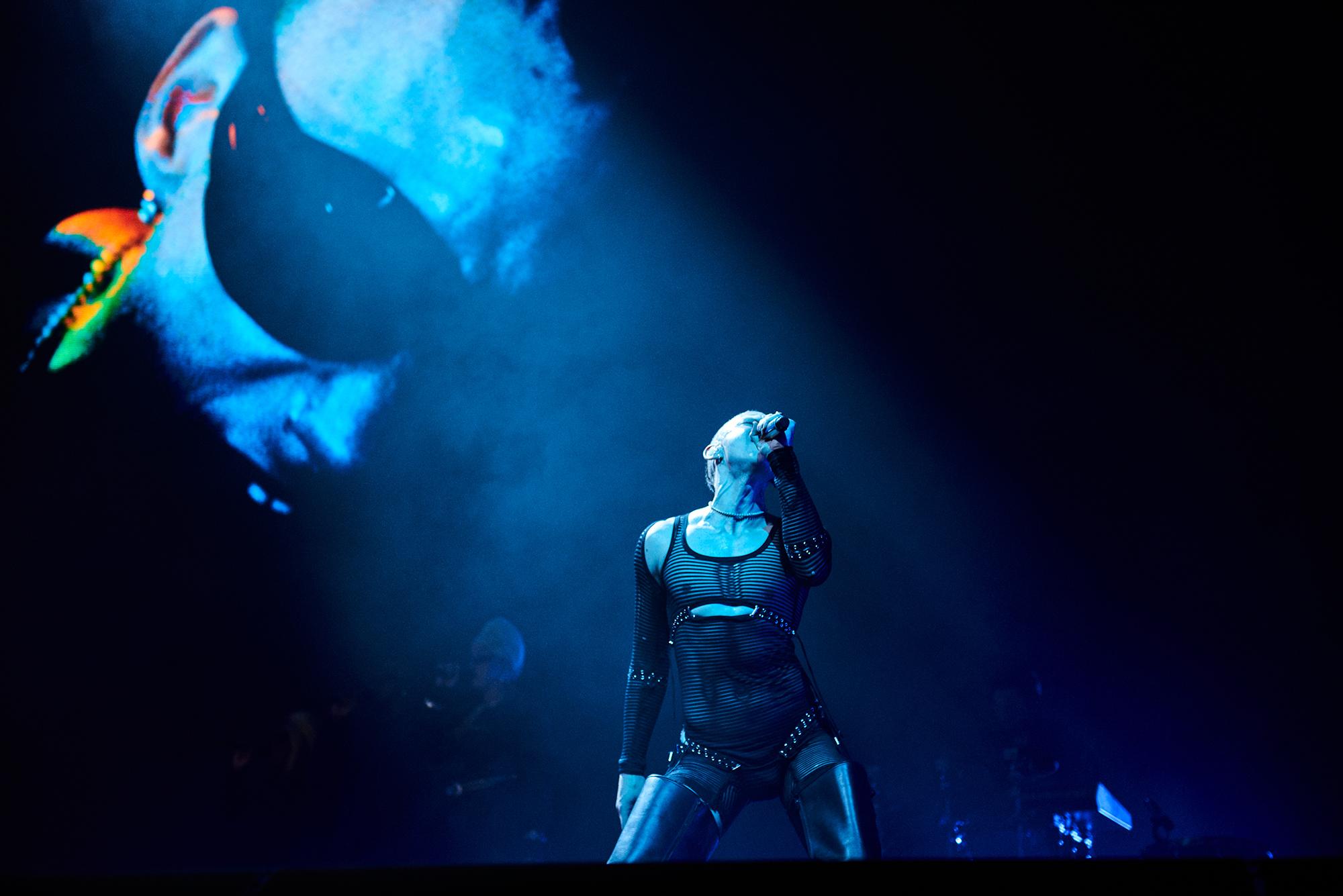 Years & Years Live image of Olly Alexander on stage under a blue spotlight taken during their live stream show recorded at OVO Arena London Years & Years